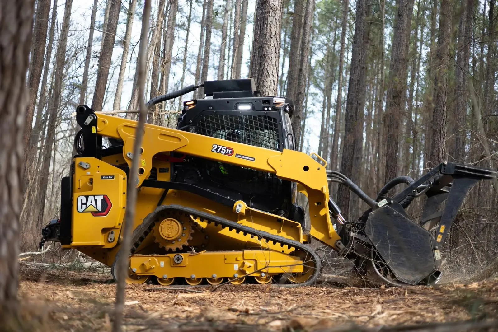 Caterpillar 275 XE compact track loader with a forestry mulcher head